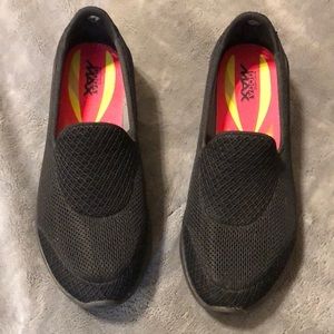 Black Skechers slip on shoes.